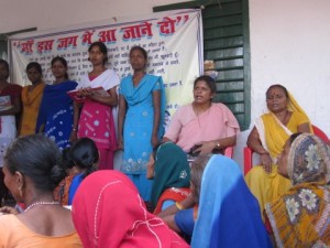 Sr Nidhi with women and sign