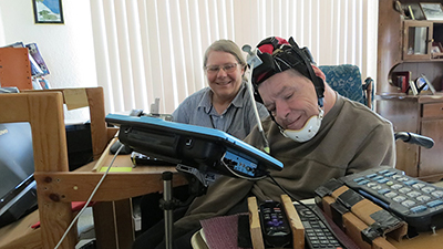 Sr. Mary Ruth’s client uses adaptive headgear so he can use the computer in his apartment to send emails or play chess.